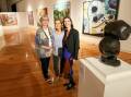 After a 125-year wait, the esteemed Wynne Prize featuring top landscape artworks has arrived at the Wagga Art Gallery. Pictured with the exhibits on Friday are gallery director Dr Lee-Anne Hall with local artist Julia Roche and WA artist Anna Louise Richardson. Picture by Les Smith