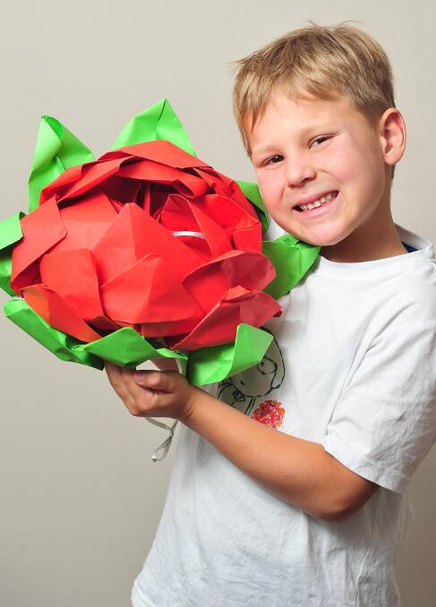 GO-GETTER: Agustin Candusso, 7, has started his own business, with help from his parents, selling his origami creations. Picture: Kieren L Tilly