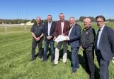 Murrumbidgee Turf Club (MTC) vice president Kevin Cross, treasurer Brett Bradley, president Geoff Harrison, minister for racing David Harris, MTC chief executive Jason Ferrario and member for Wagga Dr Joe McGirr inspect the site of the proposed stable complex on Tuesday. Picture by Matt Malone