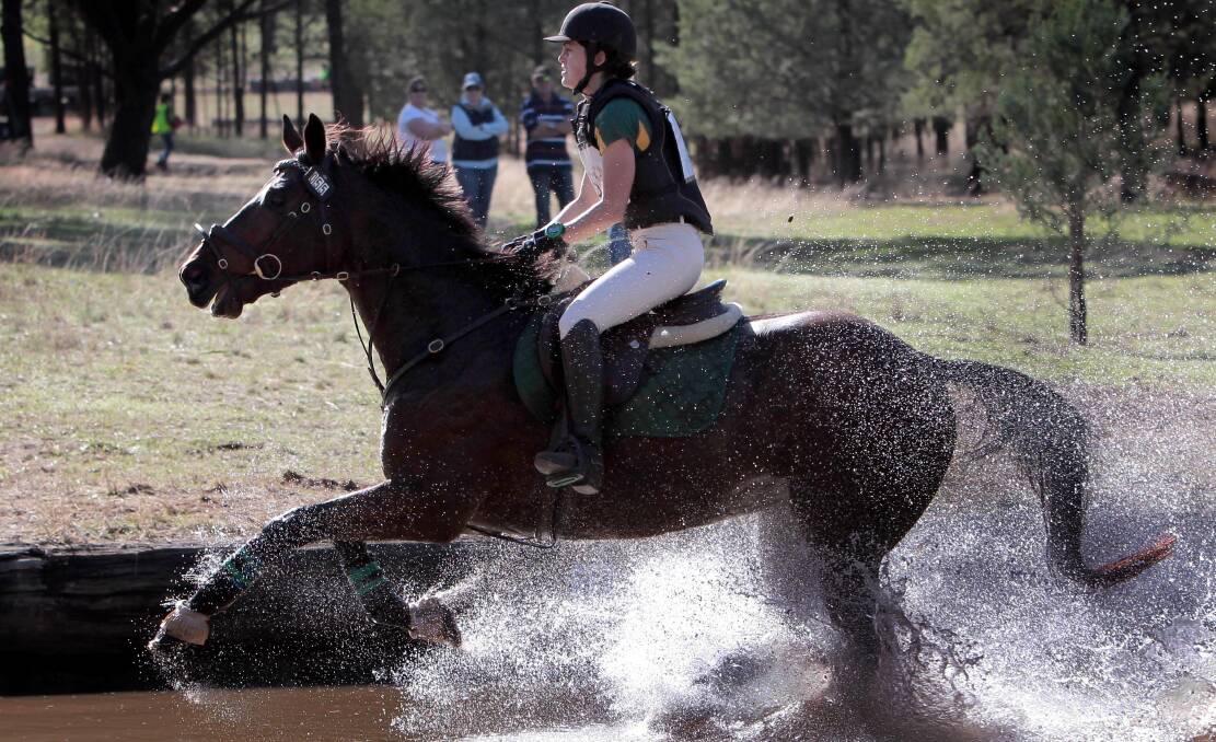 BIG SPLASH: Samantha Harrison guides Paddy's Luck through the water in the cross country course at Wagga Horse Trials on Sunday.