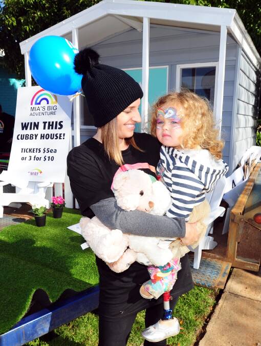 Trash to treasure: Leila Bright with her daughter Mia Stewart, 3, at Mia's Big Carpark Sale, raising money for life-changing treatment in America. Picture: Kieren L Tilly