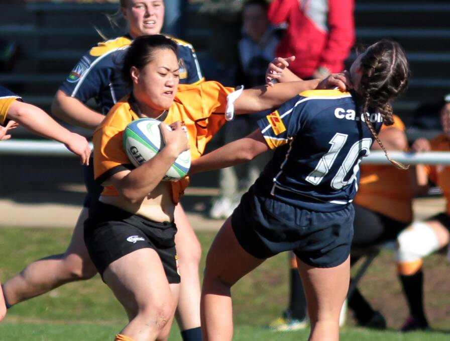 POWER: Sally Fuesaina, NSW, pushes through Sarah Carter, ACT, during the women's rugby Southern State championships at Conolly Rugby Complex at the weekend. Pictures: Les Smith