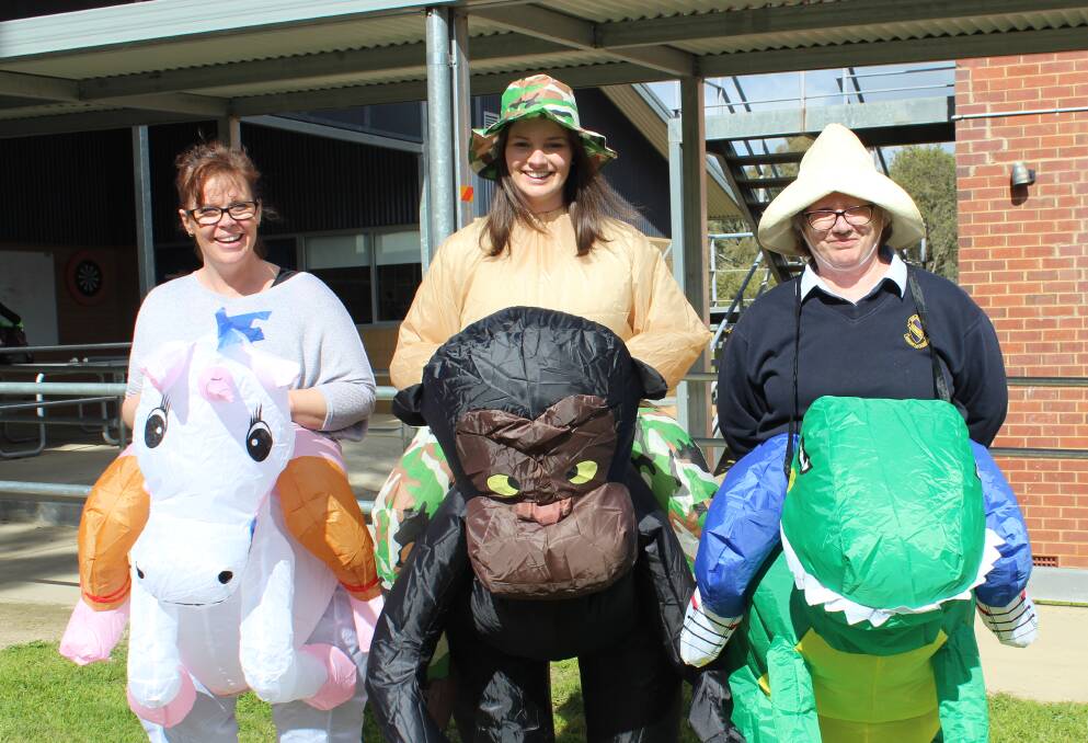 BIG SMILES: Jen Anderson, learning centre coordinator Emma Meale and Marg Belling during Book Week at Junee High School. Picture: Contributed