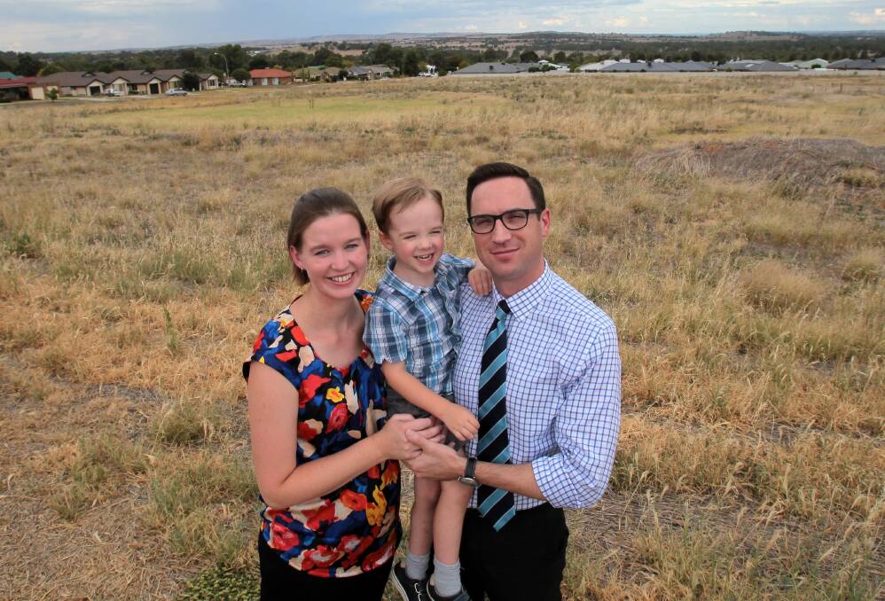 AREA OF GROWTH: Oliver Cotter, 3, with his parents Christina and Graham at the site where land has been earmarked for a future Estella school.