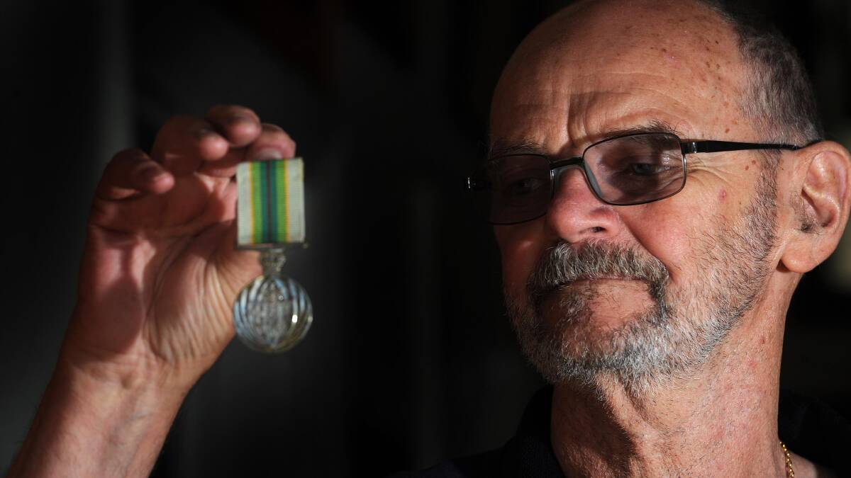 MYSTERY MEDAL: Ken May says it's important to find the owner of this Solomon Islands peace-keeping medal found beside a road. Picture: Laura Hardwick