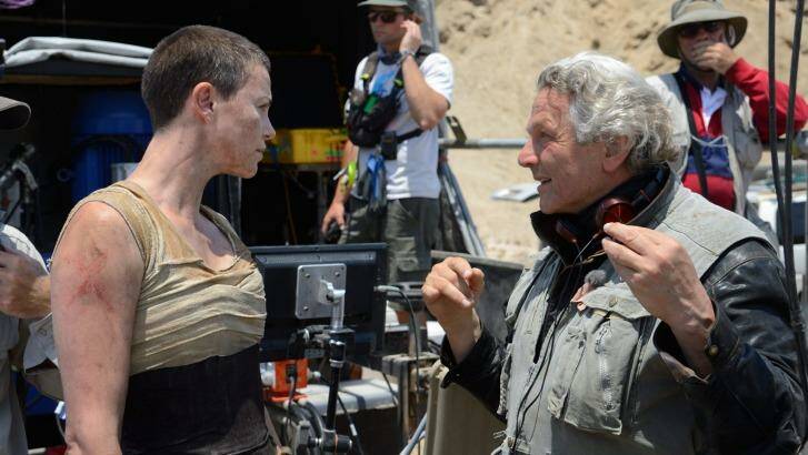 George Miller on the set of Mad Max: Fury Road with Charlize Theron. Photo: Jasin Boland