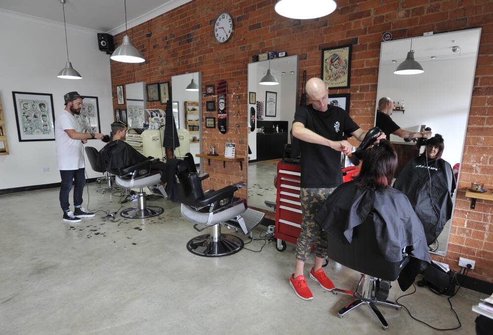 The Paper Street Social Club owners Ben Malcolm (left, standing) and Tom Dyde (right, standing) combine barber shop and salon services to offer an all-inclusive shop with a few funky features thrown in. Picture: Les Smith 