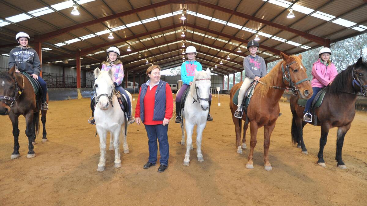 FUTURE VOLUNTEERS?: (L) Bronte Jones (on Barney), Caitlin Rodham (on Cruiser), coach Sally Cox, Millie Norman (on Gem), Tilly Limberger (on George) and Saige Garrod (on Amber) participate in the abled-bodied program run by the RDA. Picture: Alastair Brook