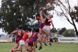 GGGM's Tom Banuelos has a marking attempt spoiled by Collingullie-Wagga's James Pope during the clash between the Demons and Lions at Crossroads Oval. Picture by Les Smith
