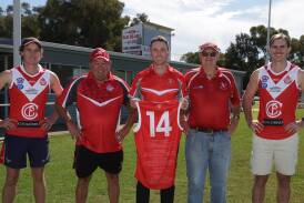 Collingullie-Wagga co-captain Ed Perryman, president Noel Penfold, 2014 premiership co-captain Kal Sykes, 1964 and 1974 premiership player Ken Morrow and vice-captain James Pope show off the one-off guernseys the Demons will wear this weekend against MCUE. Picture by Tom Dennis