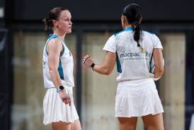 Amanda McLachlan confers with fellow umpire Betty Zhang at the Australian Men's & Mixed Netball Association national championships last month. Picture supplied