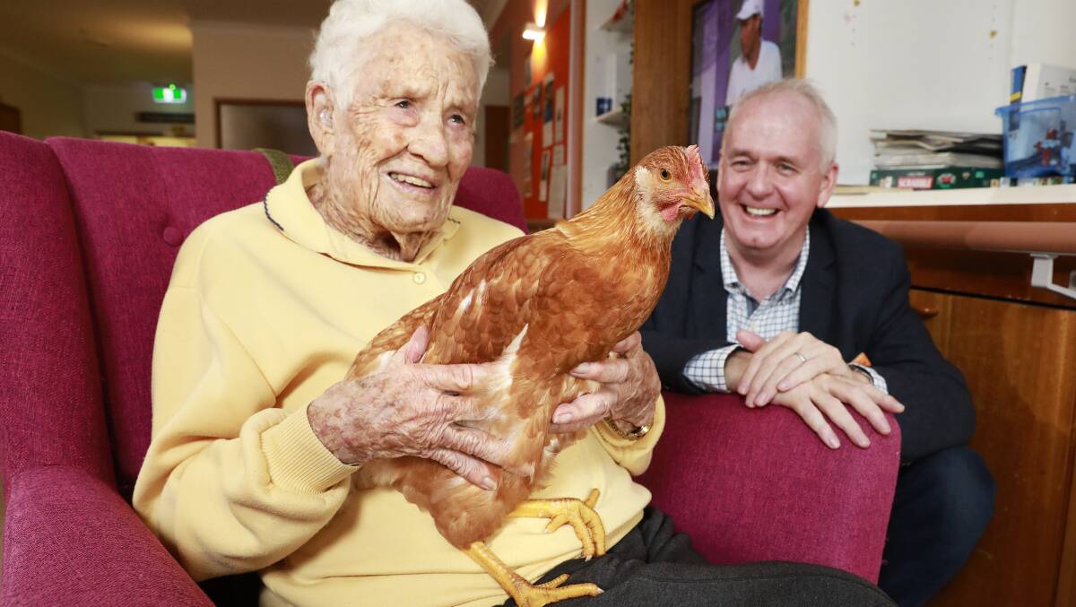 HUG-A-HEN: The chooks are free to come and go through the residents' cat flaps and enjoy a cuddle too.