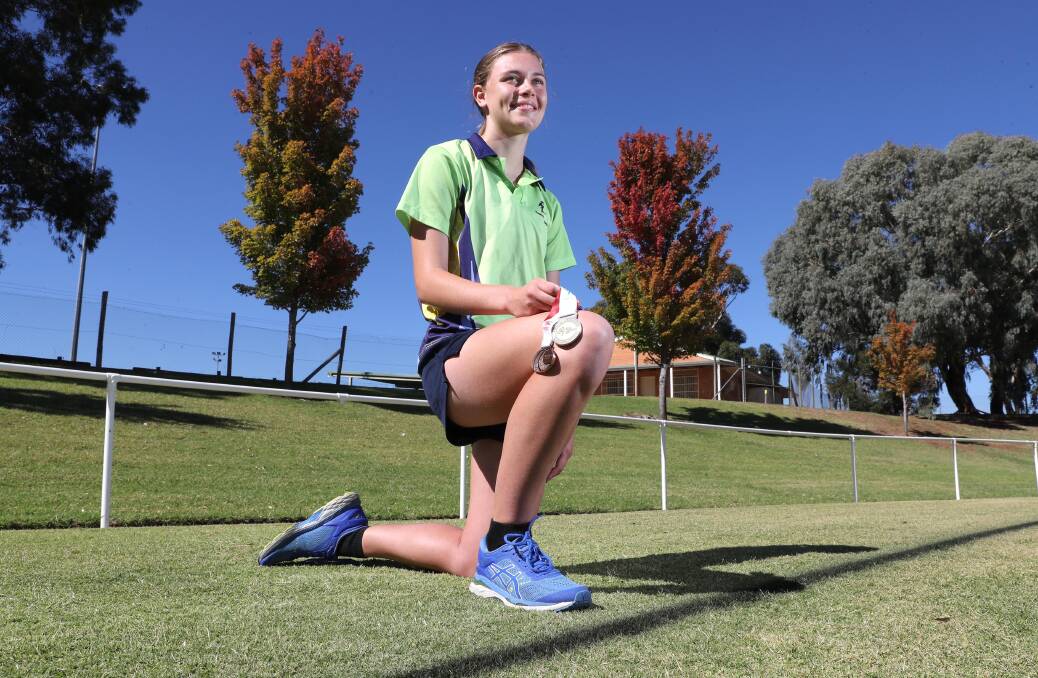 SUCCESS STORY: Hannah Mison with her gold medal from Little Athletics NSW State Championships, and bronze medal from the recent Australian Juniors athletics carnival. Picture: Les Smith 