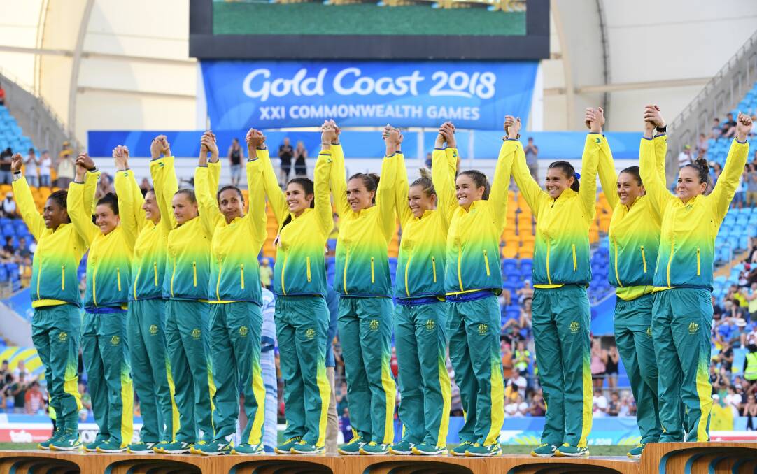 HEADS HELD HIGH: The Australian women's rugby sevens team on the podium on Sunday. Picture: AAP