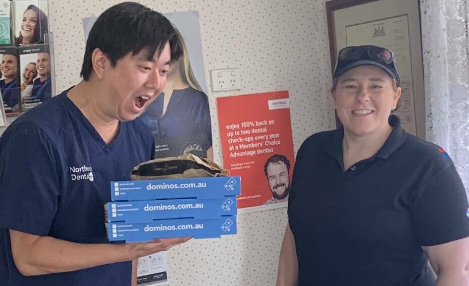 Dr Dale from North West Dental was thrilled with the pizza delivery from Jill Adams. Photo: Domino's Moree