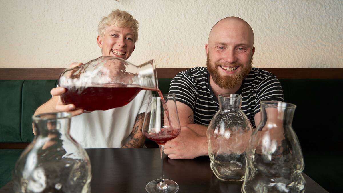 Dash Rumble and Ross McQuinn with the decanters, designed by Scott Chaseling. Picture: Matt Loxton