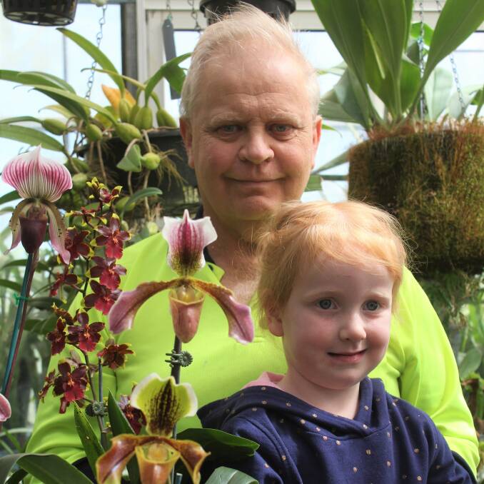 In Bloom: Wagga Orchid Society vice-president Patrick Tenison, with his grandaughter Lyra, 4, invites residents to the Annual Spring Orchid Show this weekend. Picure: Steff Wills 