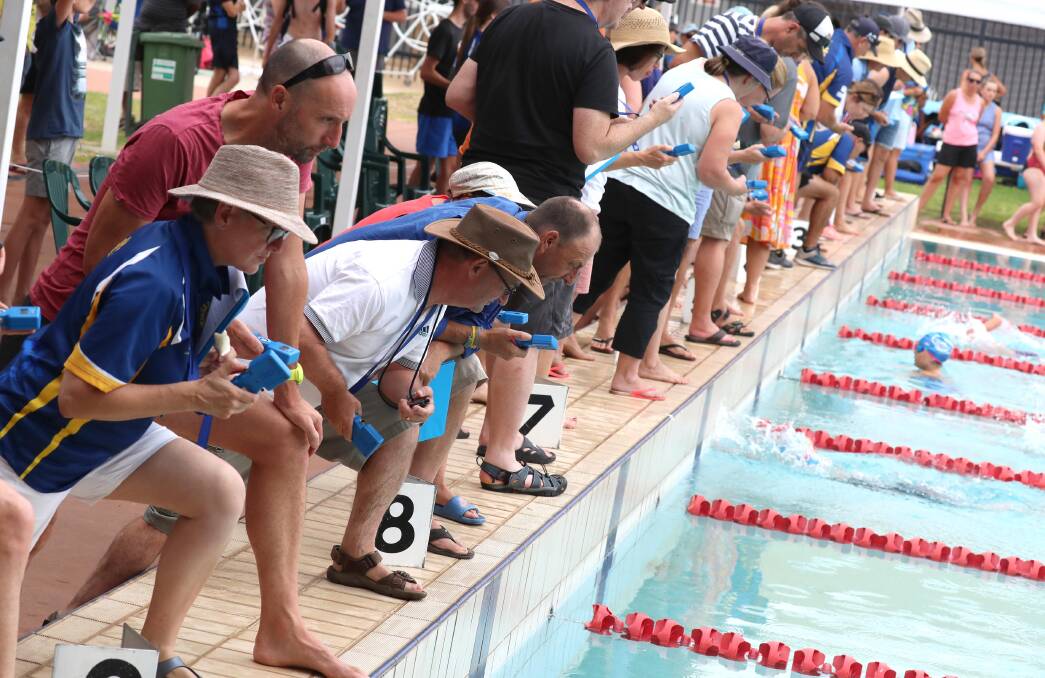 OFF AND RACING: The timekeepers are on full alert at the NSW Country Swim Meet held at the Oasis Regional Aquatic Centre at the weekend. Picture: Les Smith