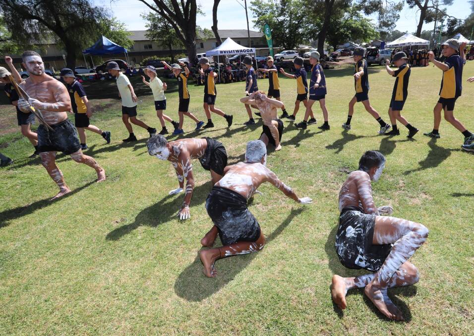 LEARNING: South Wagga Public School students learn some traditional dance moves during the NRL cultural day at Bolton Park last week. Picture: Les Smith