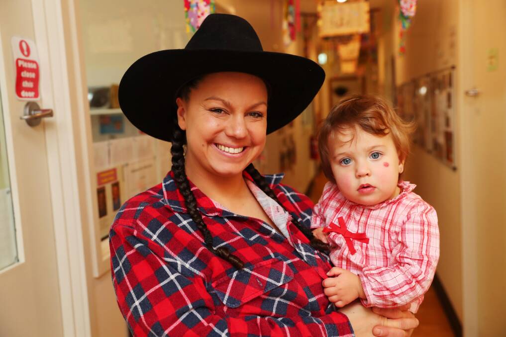 COWGIRLS: Jade Ball and Mia Heffernan, 1, are in the spirit at the Early Learning Farmer fundraiser last week. Picture: Emma Hillier