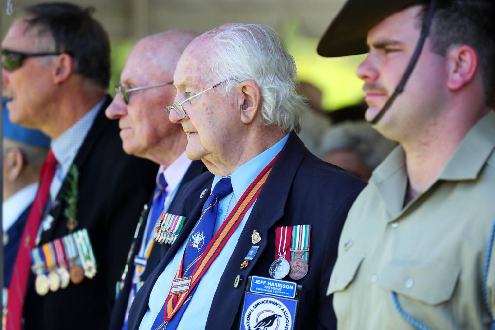 RESPECT: John Ploenges, Jeff Harrison and Private Dale Abbott pay their respects at the Remembrance Day service on Sunday last week at the Victory Memorial Gardens. Picture: Emma Hillier