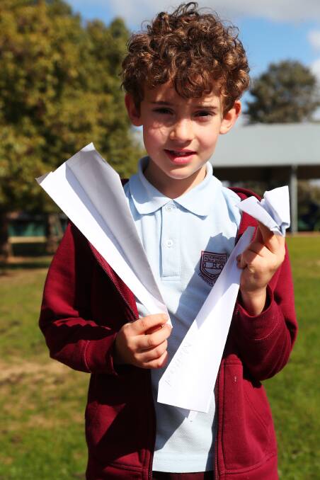 FLYING HIGH: Michael Johnson, 8, with his paper planes made during National Science Week.