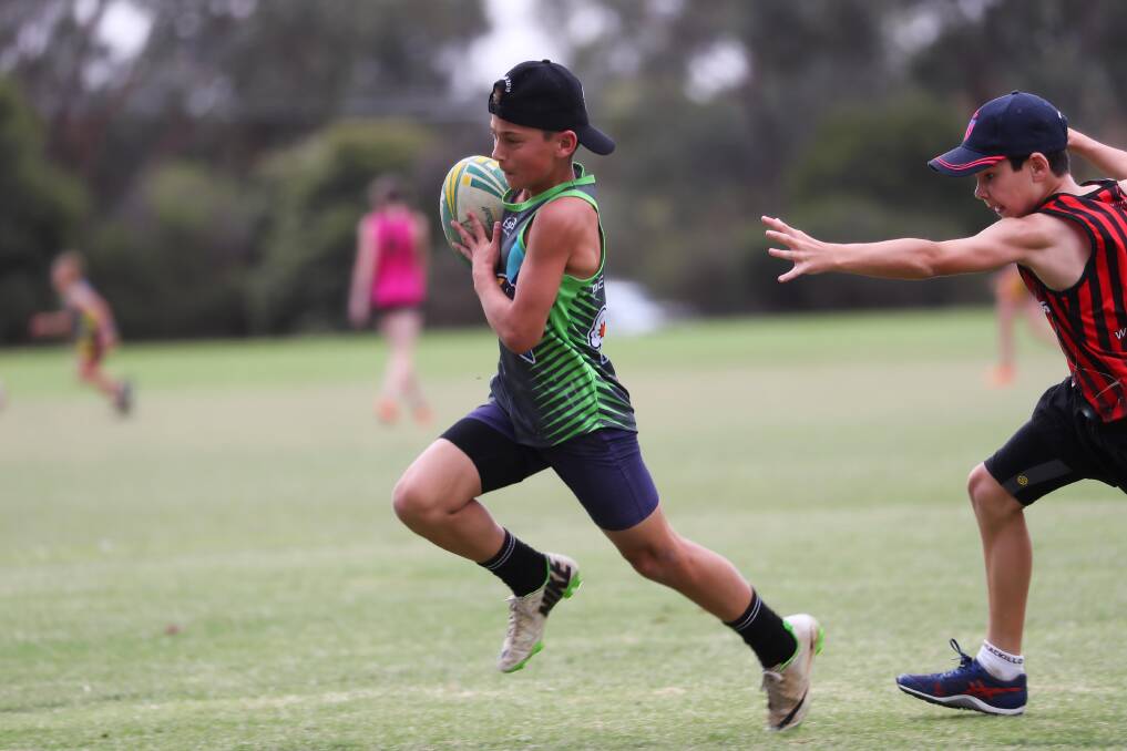 RUN: Oscar Perrot makes a good run in the under 12s boys' touch grand final. Picture: Emma Hillier
