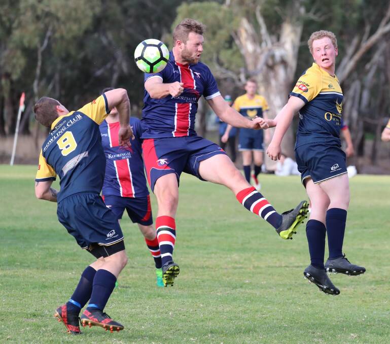 JUMP: Lachlan Philipse, Brad Ingram and Ben Cooke all brace for impact in the Henwood Park v Junee soccer match at Rawlings Park at the weekend. Picture: Les Smith