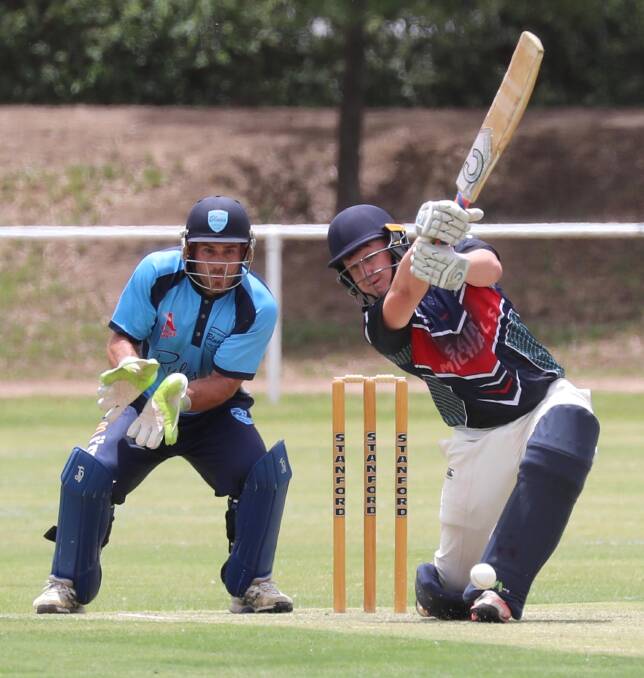 HIT: Beck Frostick and keeper Jeremy Rowe in St Michaels v South Wagga match. Picture: Les Smith