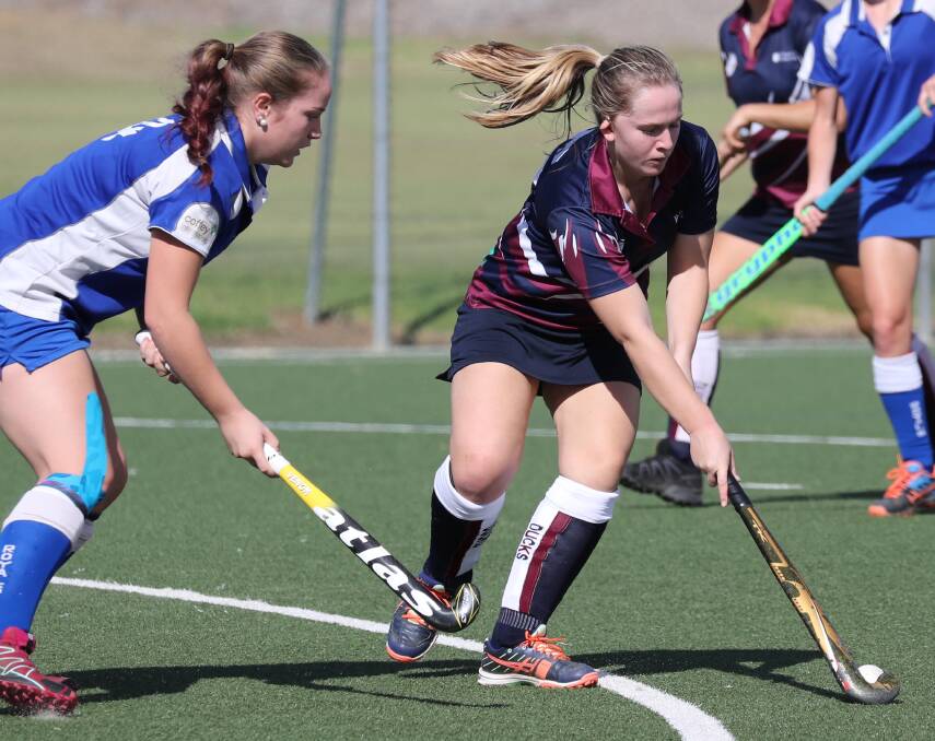HOCKEY: Ashleigh Yan and Sophie Gough fight for possession during the CSU-Rivcoll and Royal division one women's hockey at Jubilee Park at the weekend. Picture: Les Smith