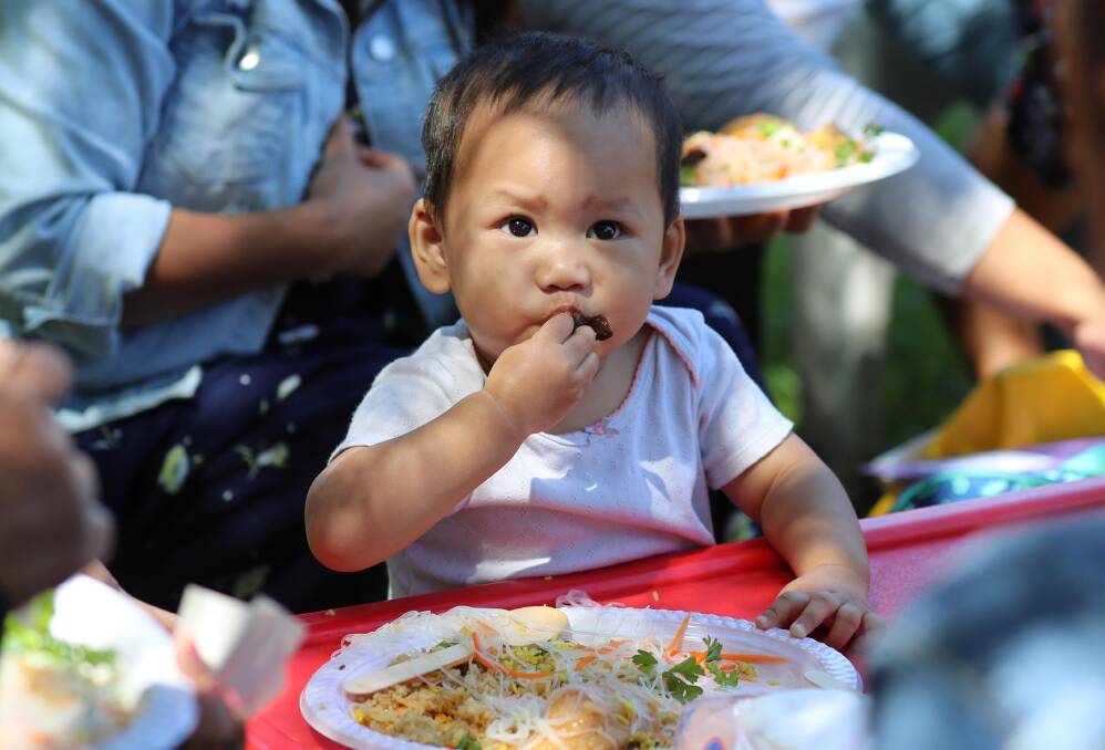 DINNER TIME: Atarah Thanya, 18 months, enjoys her food at the Women's Expo 2019 at the Wagga Multicultural Centre last week. Picture: Les Smith 