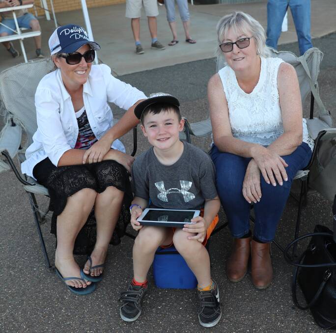 TROTS: Rebecca Brewer, Billy Madsen, 8, and Christine Brewer at Junee trots. 