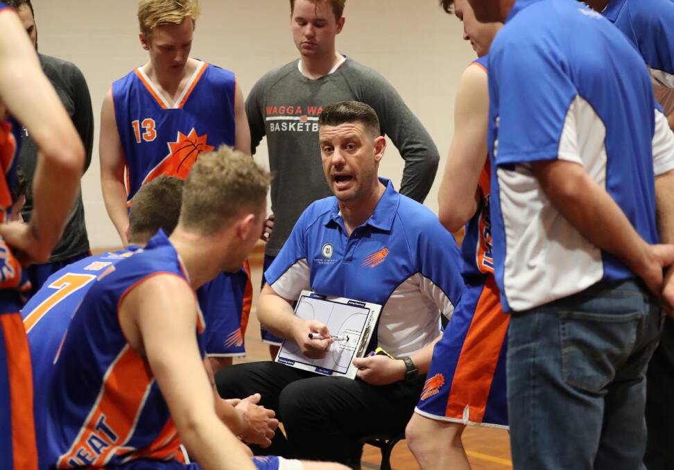 PEP: Wagga Heat coach Matt Bishop explains the play. Picture: Les Smith