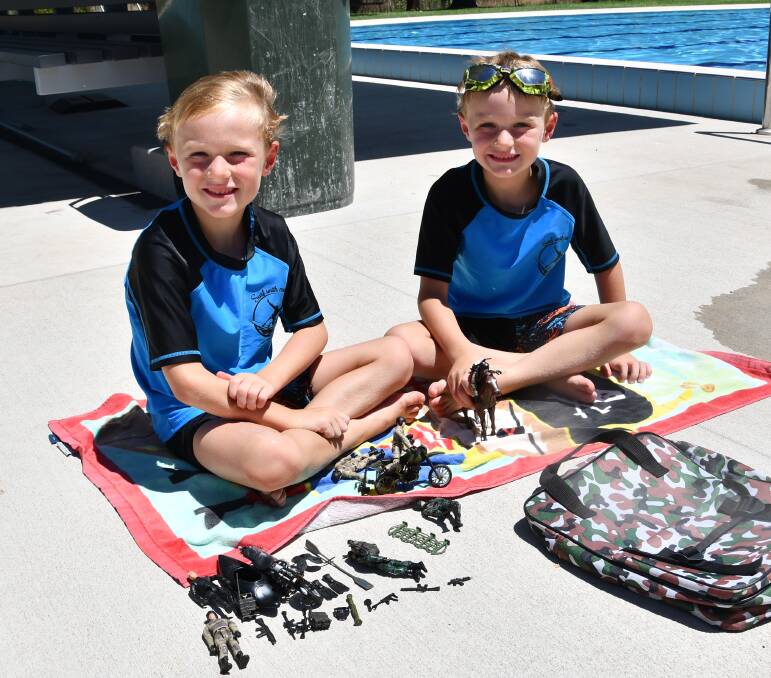 DAY OUT: Five-year-old twins Zye and Zayne Liddell came prepared for a day at the Holbrook swimming pool with their soldier models last week. Picture: Lorri Roden