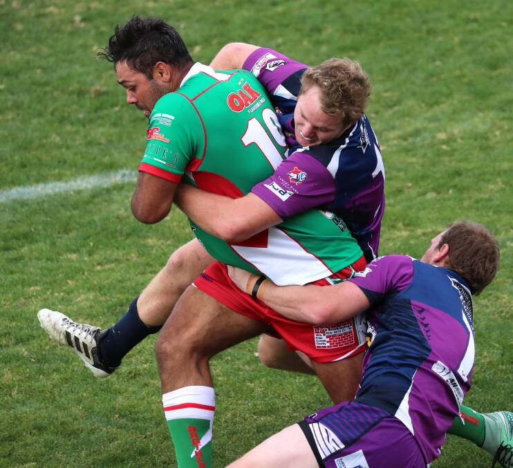 GOTCHA: Will Merritt is tackled by Tim Hurst and Kyle McCarthy in the Brothers and Southcity group 9 match at McDonald's Park. Picture: Les Smith