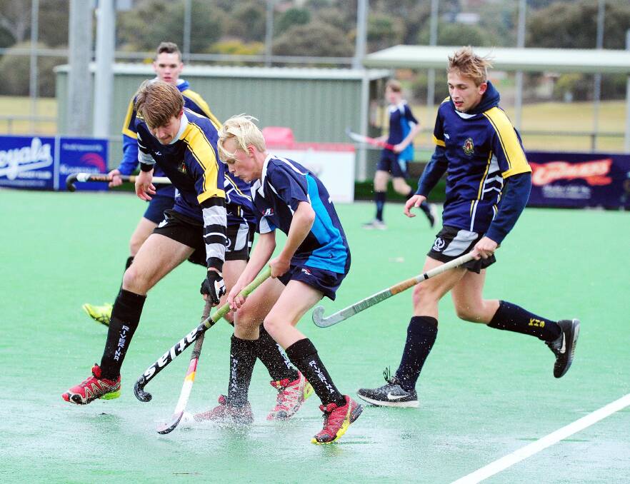 Wagga's Jack Boyd fights for possession during the Wagga High and Kooringal combined Wagga hockey final at Jubilee on Monday. Picture: Kieren L Tilly