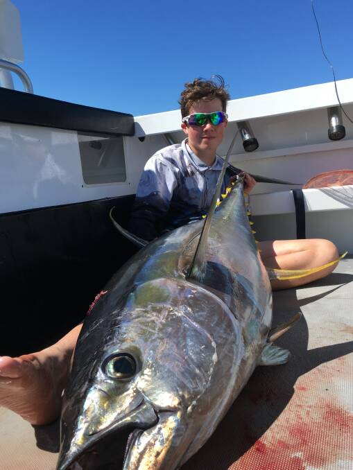 SOLID CATCH: Tully Forbes, 53kgs, with a massive 58kg yellowfin caught recently. Pictures to craig@waggamarine.com.au.