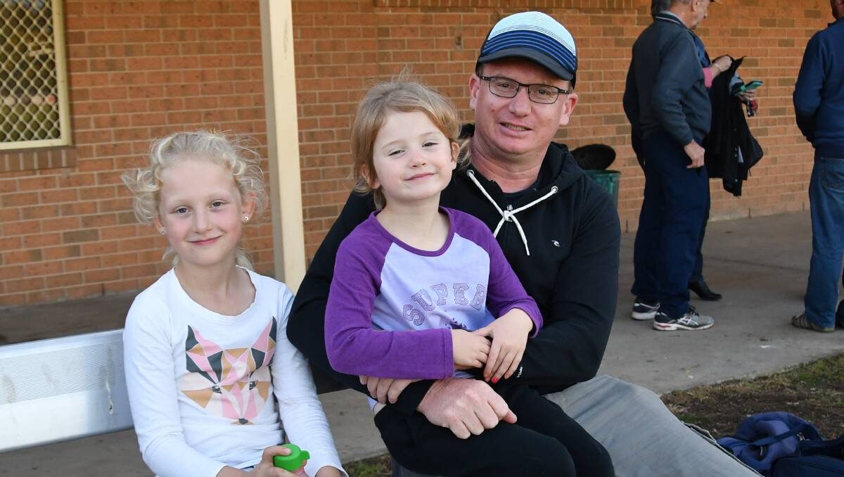 FOOTY INTEREST:  Isla, 7, Elle, 5, with their dad Mat Geddes of Culcairn, having some special father daughter time at the footy. Picture: Lorri Roden