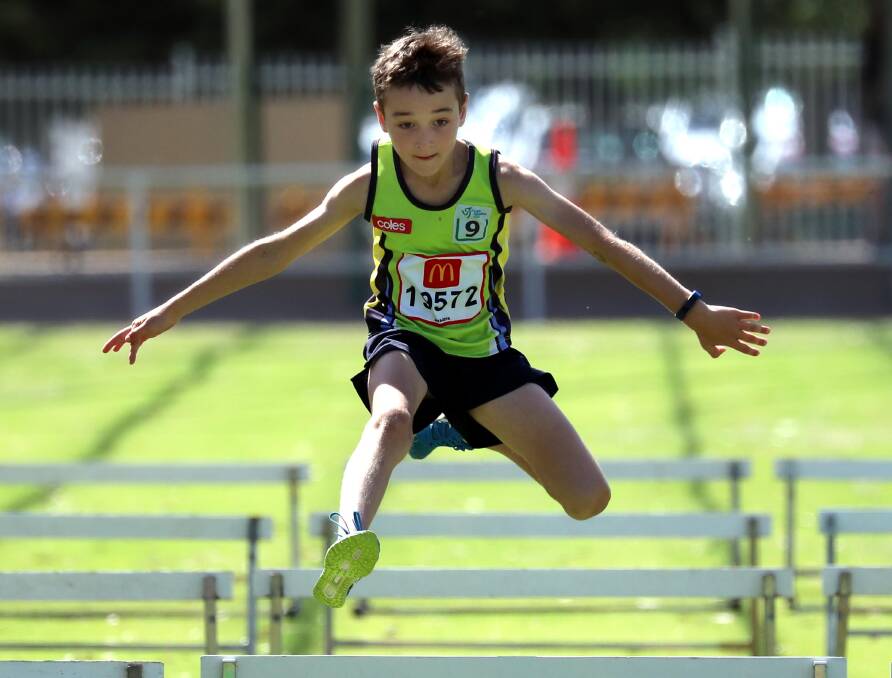 FLYING: Harrison Fanning soars during the nine years boys' hurdles over 60 metres during the  Kooginal-Wagga Athletics Club's 40th annual carnival at Jubilee Park. Picture: Les Smith