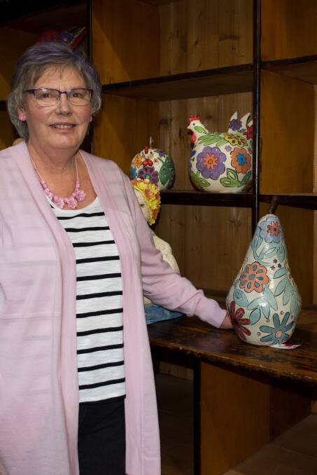 PEARY-GOOD: Christine Blair with her winning ceramic, named Colour Me Happy Pear, at the Coolamon Up2Date Art Exhibition recently. Picture: Contributed
