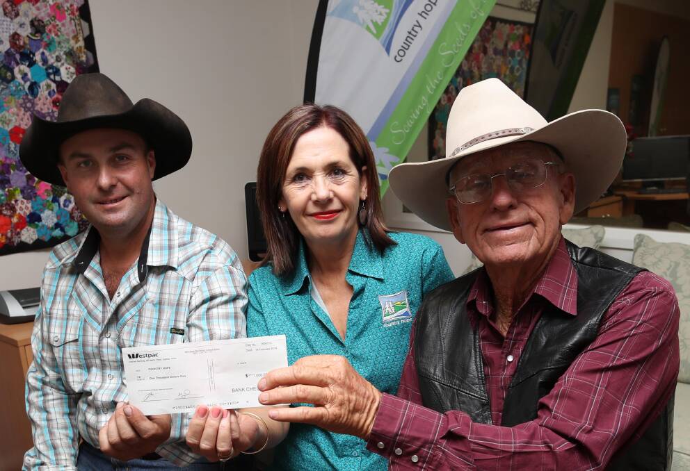 GOOD DEED: President of The Rock rodeo Jade Bryon, general manager Country Hope Wagga Ellie Webb, and rodeo producer John Gill, as the Pro Rodeo donates $1000 to Country Hope. Picture: Les Smith