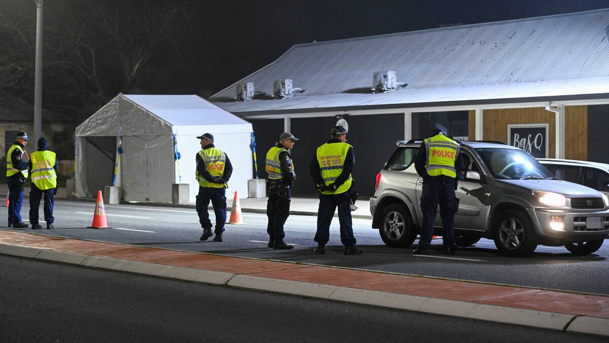 Stop and look: Police are continuing to check the documentation of motorists around-the-clock at the Wodonga Place entrance into Albury. Picture: MARK JESSER