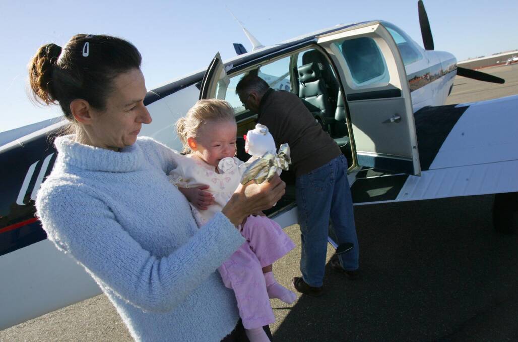 Wendy Fields and daughter Anastaissa prepare to fly to Sydney in 2006 for medical treatment by pilot Mike Scarce on an Angel Flight.
