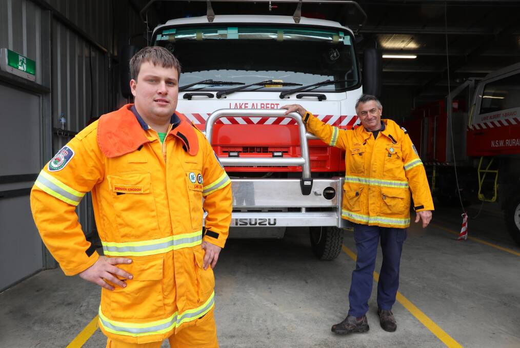 VOLUNTEER TIME: Brendan Kingdom and Lake Albert RFS captain Jeff Crawford ready their equipment for training. Picture: Les Smith 