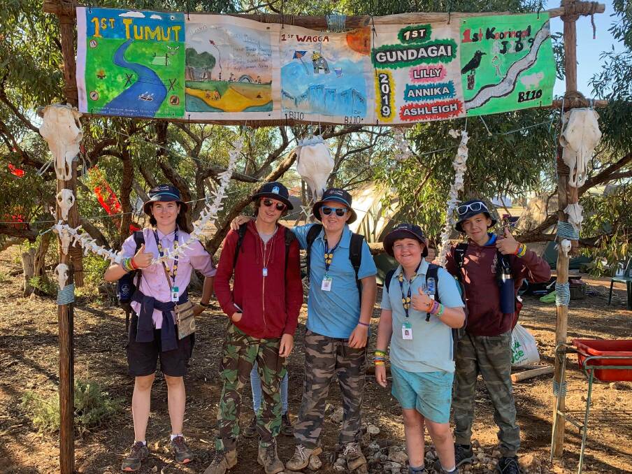 READY FOR FUN: Riverina Scouts Maddison Pitstock (Wagga), Nicolas Hayes and Trevor Hodge (Hay), and Nicholas Anderson and Lachlan Garnock (Kooringal) in front of the camp gate built by Riverina Scouts. 
