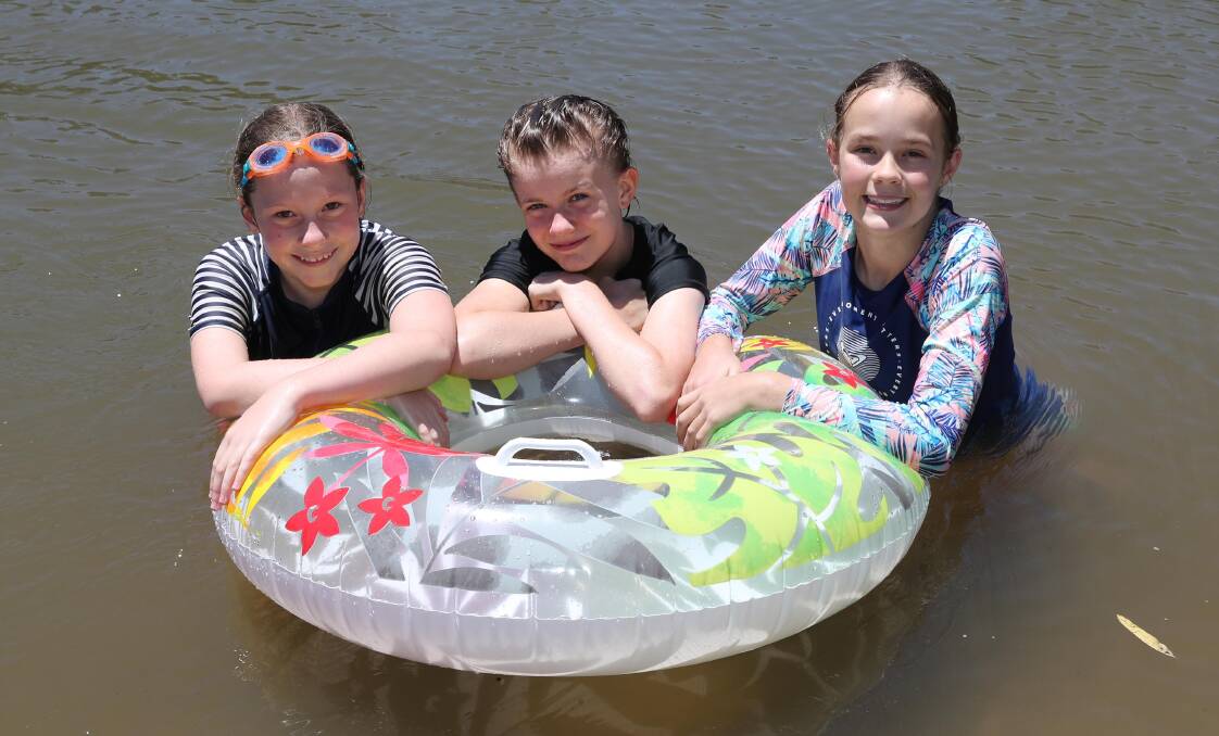 COOL DOWN: Wagga girls Eleanor Waters-Jones, 13, Josie Crofts, 12 and Claire Heazlewood, 12, at Wagga Beach on Friday. Picture: Les Smith