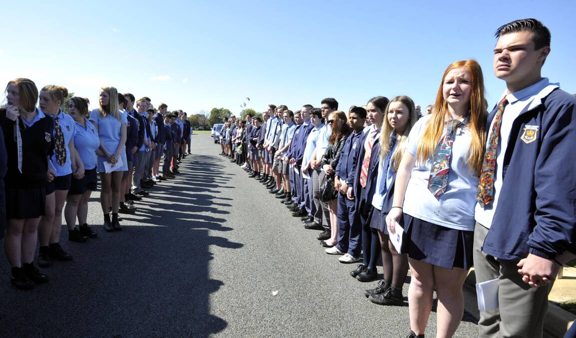 United: Wagga High School students formed a guard of honour at the funeral of Ron Anschuetz on Friday. Picture: Les Smith. 