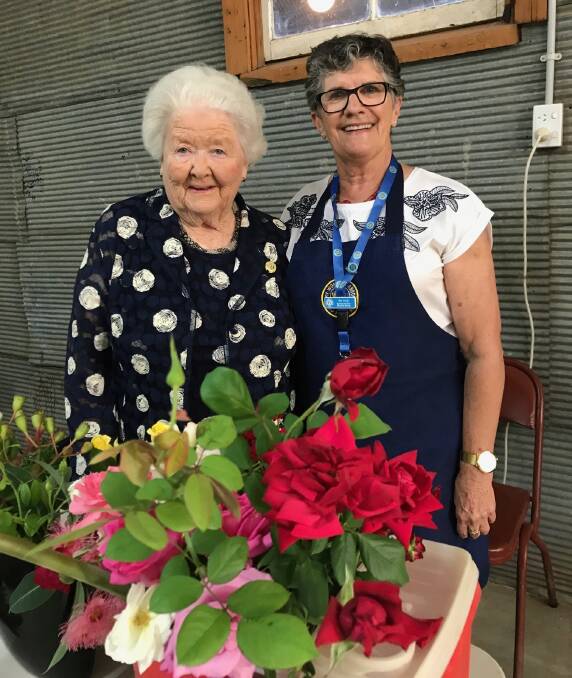 MEMORABLE: Barbara Parnell and Pat Ceely share a moment at Euberta Hall. Barbara demonstrated floral art. 