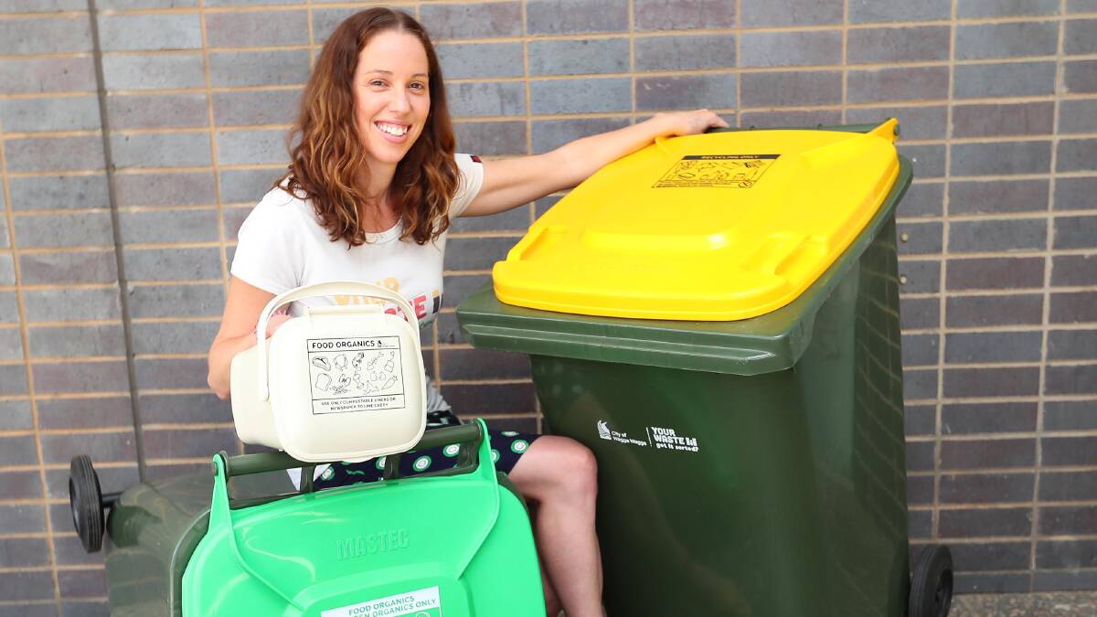 FRESH WHEELS: Council waste education and communications officer showcases the new bins. Delivery to Glenfield Park and Lloyd commenced today.