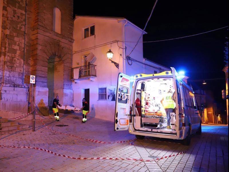 A woman is rescued by medical personnel after a 5.3 earthquake in Italy.